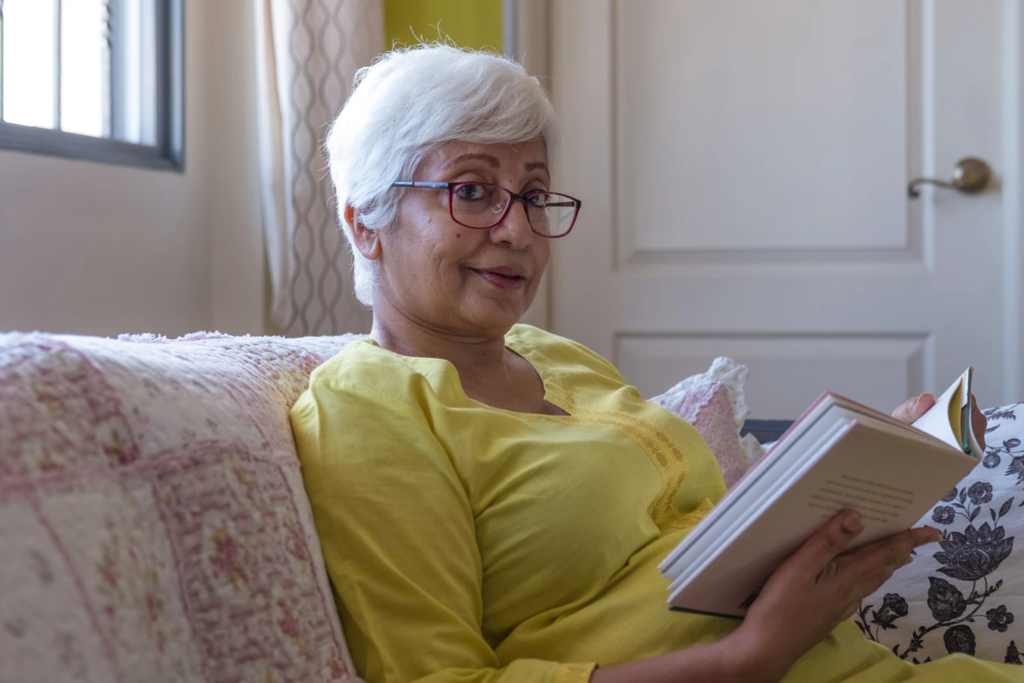 Senior woman reading in her home.