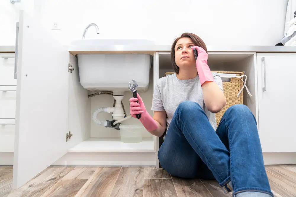 Woman with plumbing problems at home