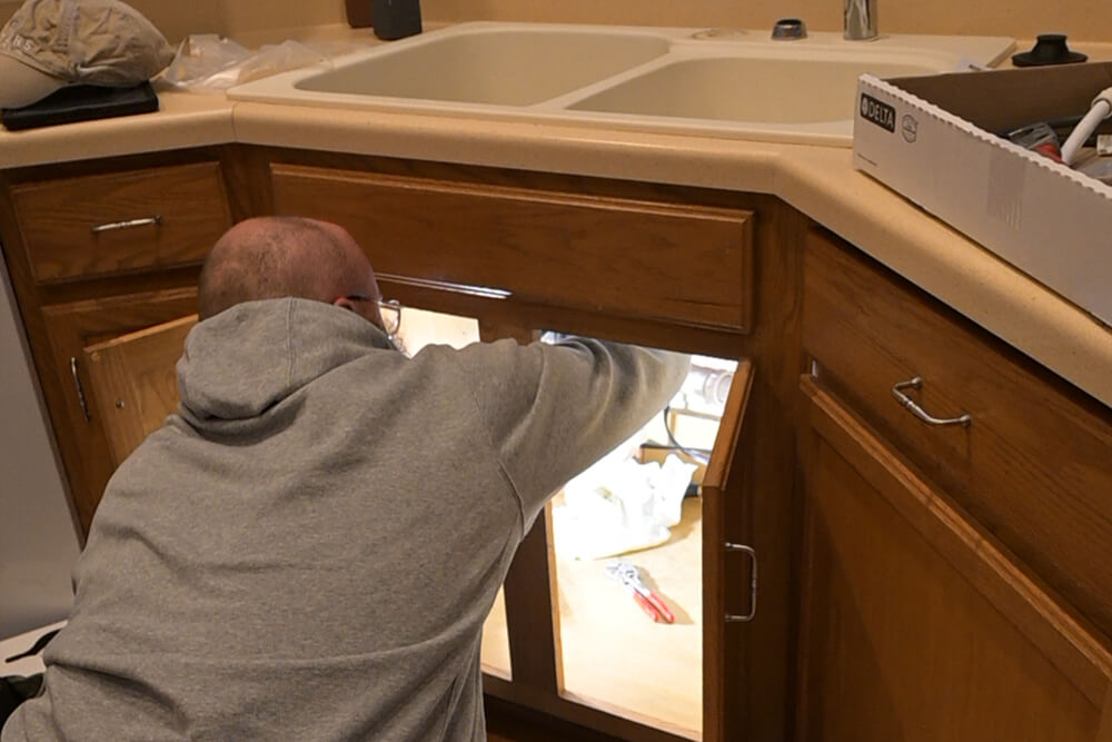 Team member working on a sink